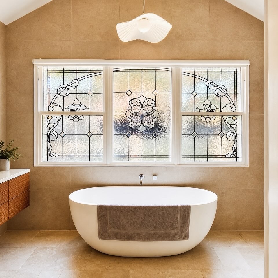 Elegant bathroom with freestanding bath and leadlight feature window