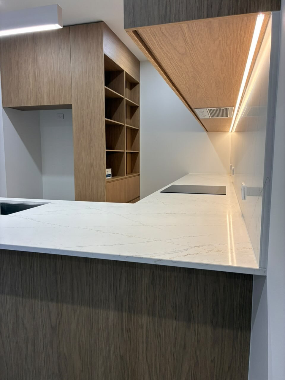 Marble kitchen benchtop with feature joinery and angled timber ceiling detail