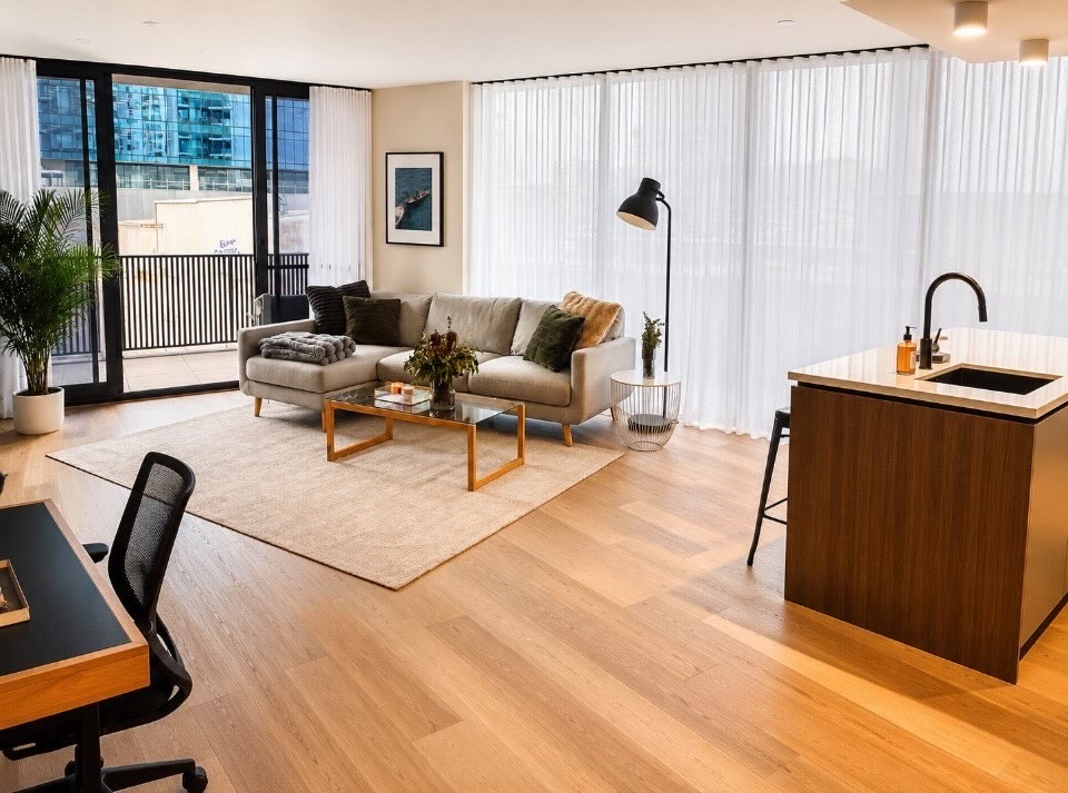Bright open-plan living and kitchen area with polished timber floors