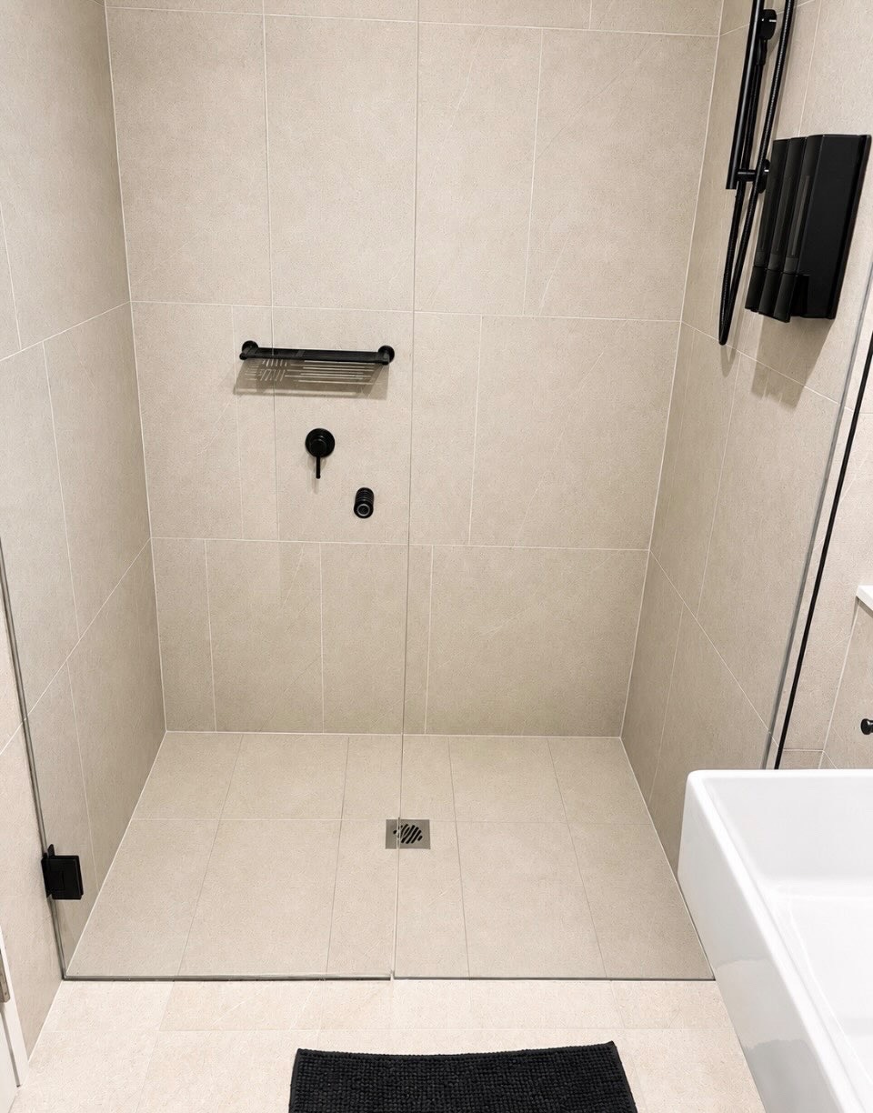 Immaculate tiled walk-in shower with matte black fixtures