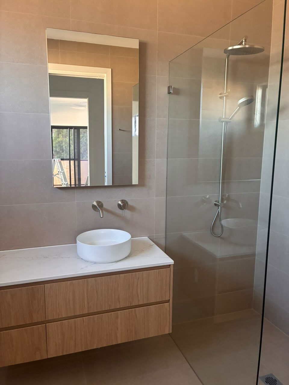 Spotless ensuite with round vessel basin, timber vanity and walk-in shower